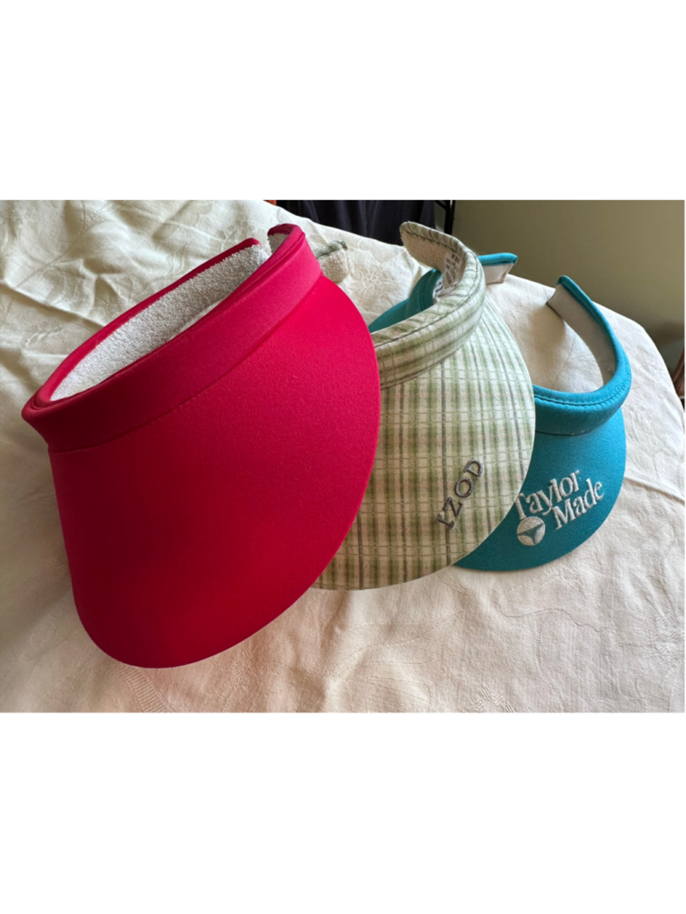 3 Women's sun visors. Izod, TaylorMade and red unbranded.